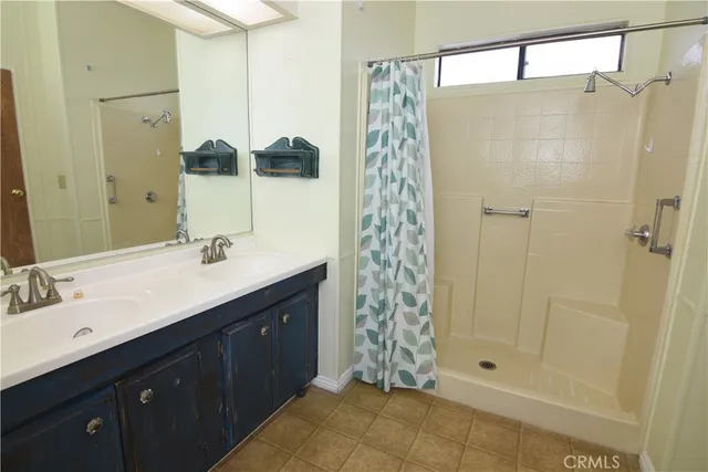 a bathroom with a shower sink and mirror
