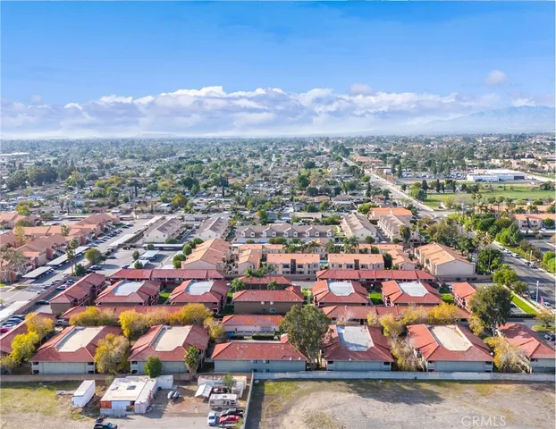 an aerial view of residential houses with outdoor space