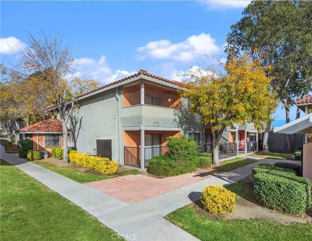 a front view of a building with a garden