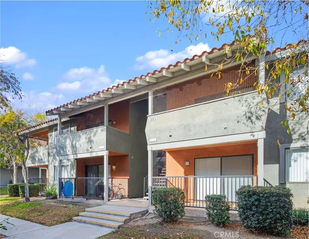 a large building with a large window and parking space