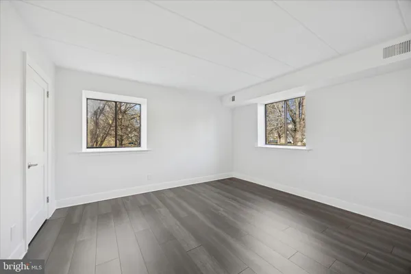 a view of a room with wooden floor and window
