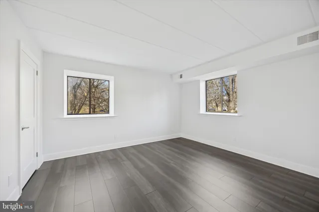 a view of a room with wooden floor and window