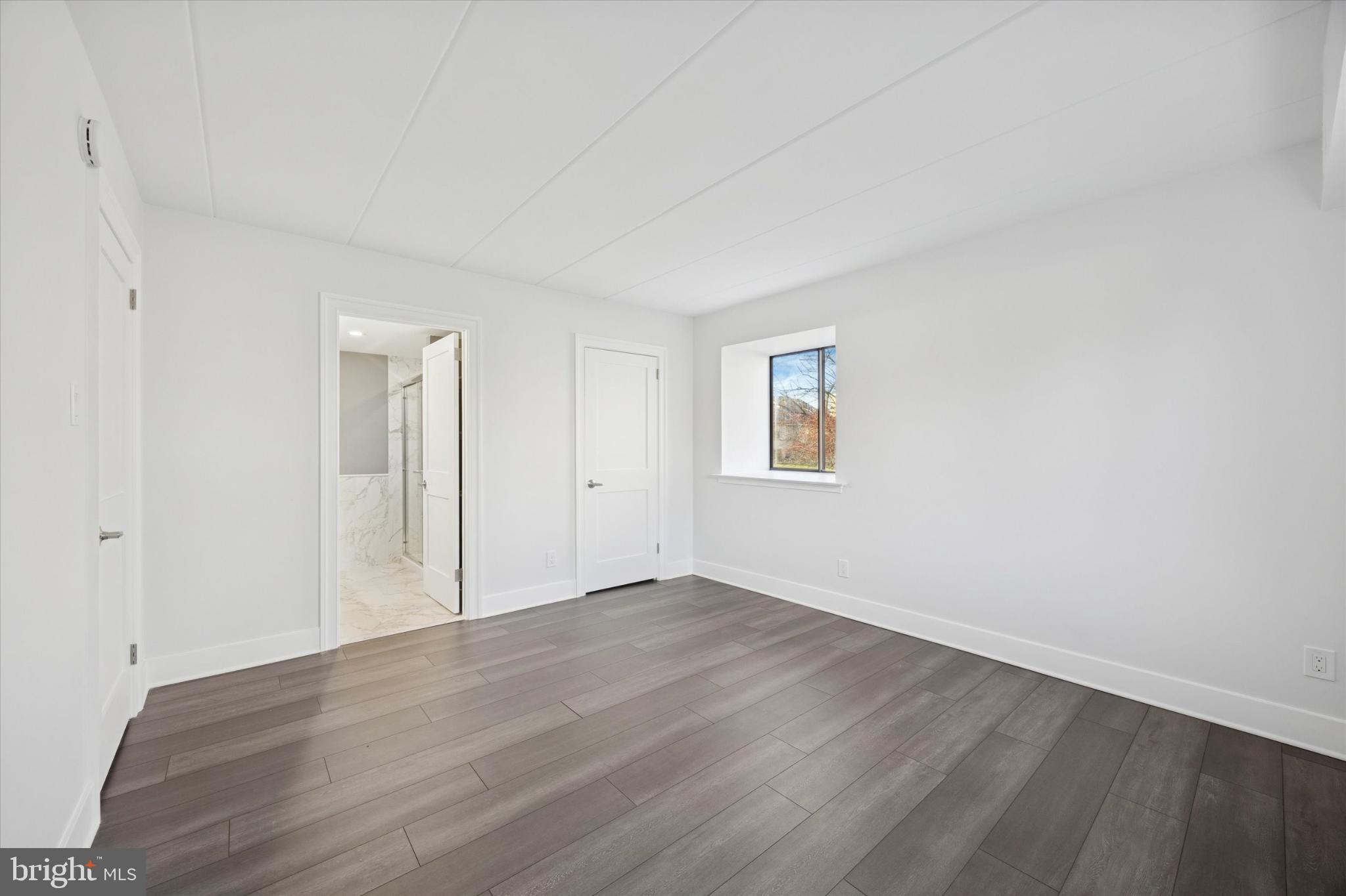 40 Le Forge Court, Unit 40 Chesterbrook, PA 19087 - Photo 12 of 16 an empty room with wooden floor and windows