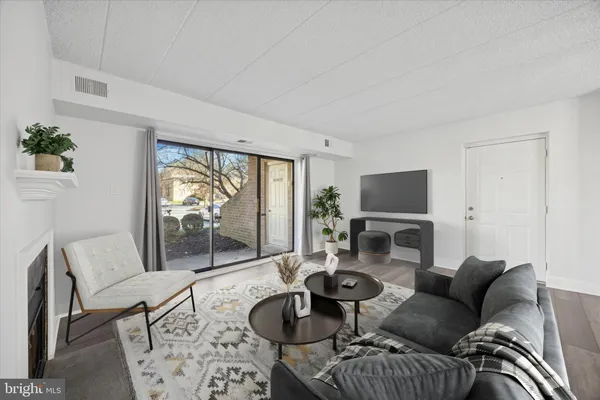 a living room with furniture a flat screen tv and a large window