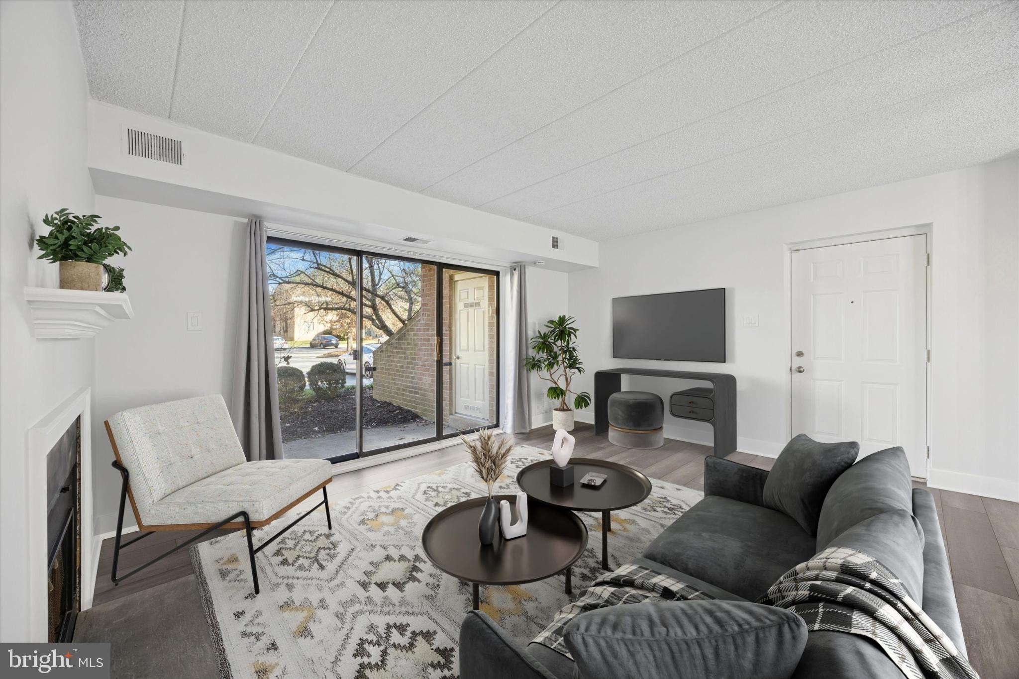 40 Le Forge Court, Unit 40 Chesterbrook, PA 19087 - Photo 2 of 16 a living room with furniture a flat screen tv and a large window