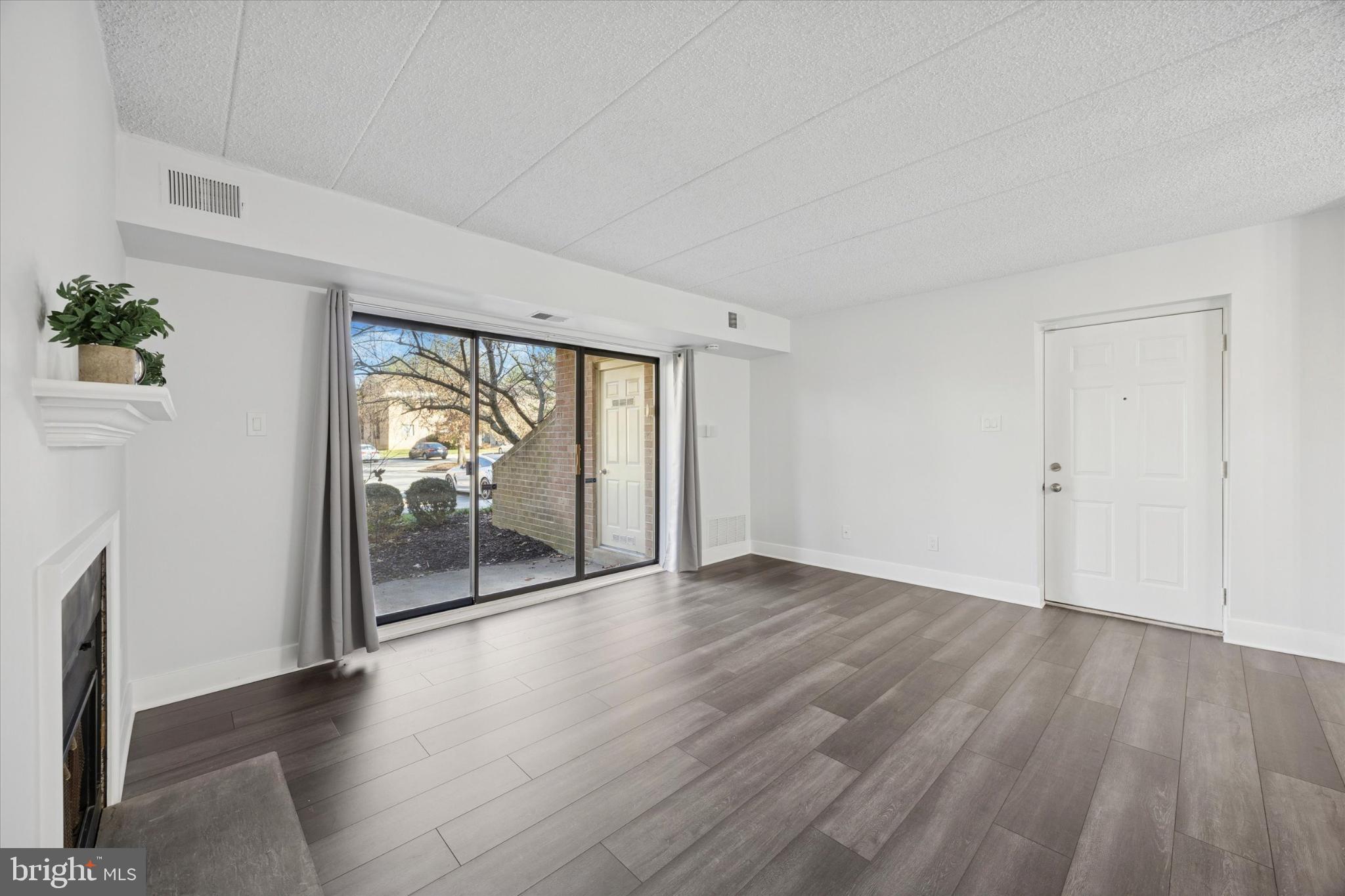 40 Le Forge Court, Unit 40 Chesterbrook, PA 19087 - Photo 3 of 16 an empty room with wooden floor and windows