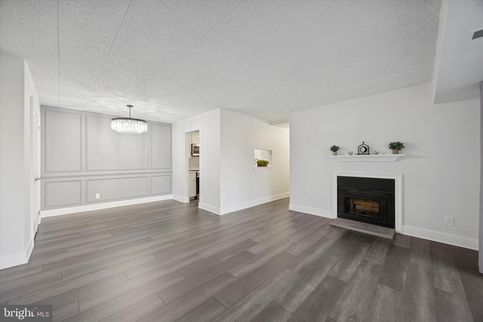 40 Le Forge Court, Unit 40 Chesterbrook, PA 19087 - Photo 6 of 16 a view of an empty room with wooden floor fireplace and a window