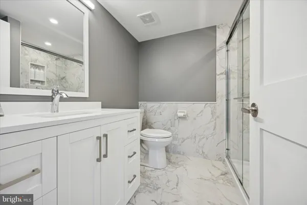 a bathroom with a sink toilet and shower