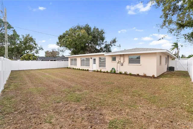 a view of a house with a backyard