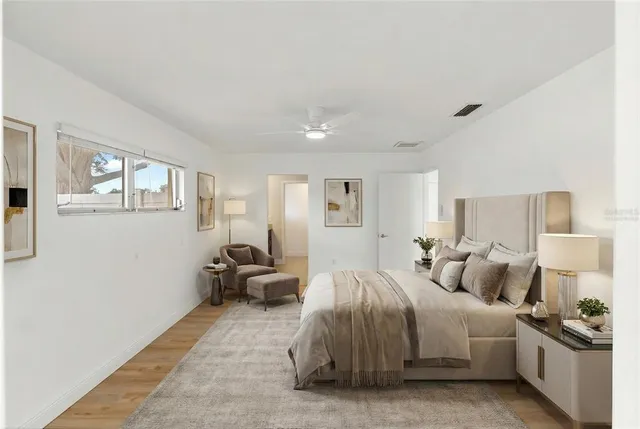 a bedroom with a bed and wooden floor