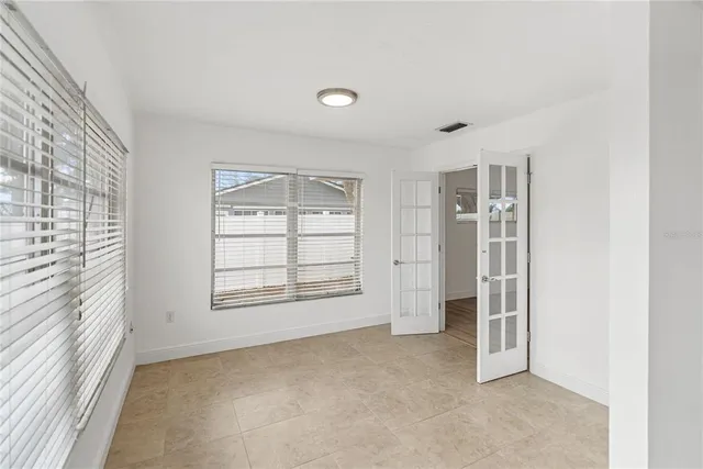 an empty room with windows and closet