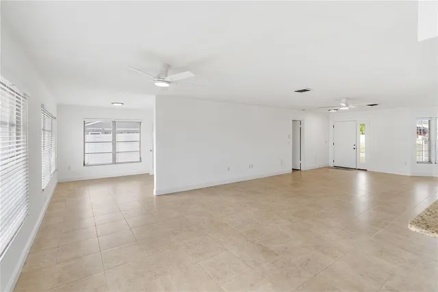 an empty room with windows and painted walls