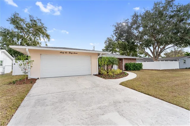 a view of a house with a yard and garage