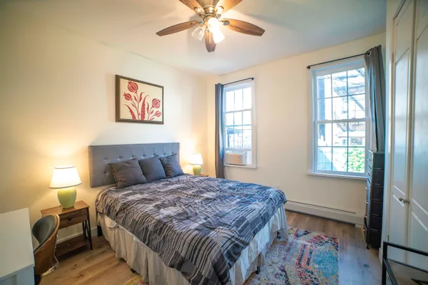 a bedroom with a bed and a window