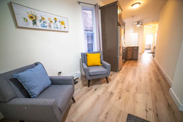 a living room with furniture and wooden floor