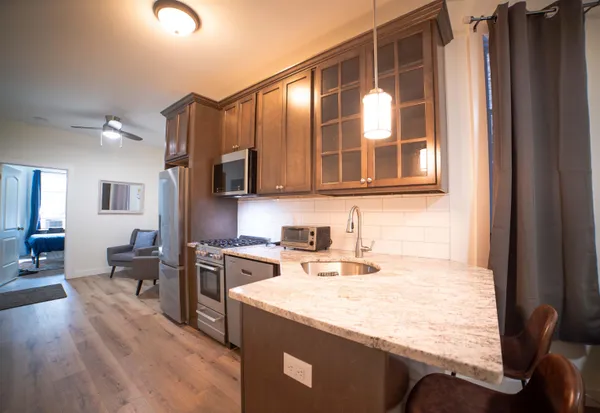 a kitchen with a stove a sink and a microwave