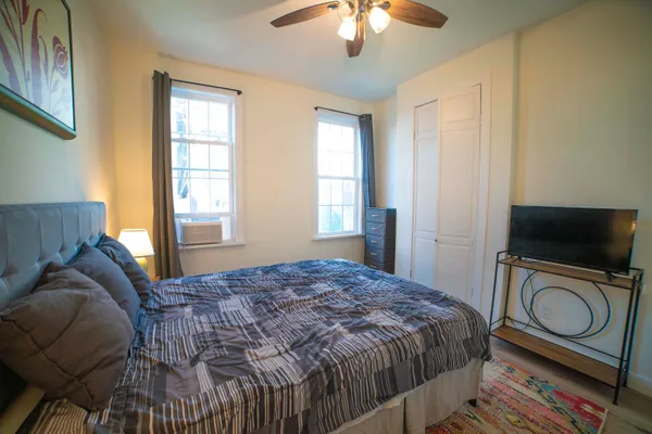 a bedroom with a bed and a chandelier