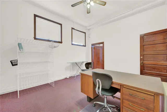 a view of a hallway with wooden floor and furniture