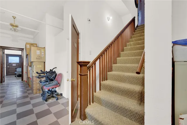 a bathroom with a toilet a sink and shower curtain