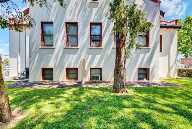 a view of a house with a large window and yard
