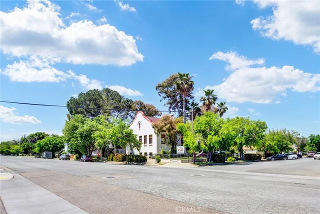 a view of a house with a tree in front of it