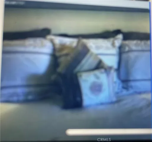 a view of a street with cars parked