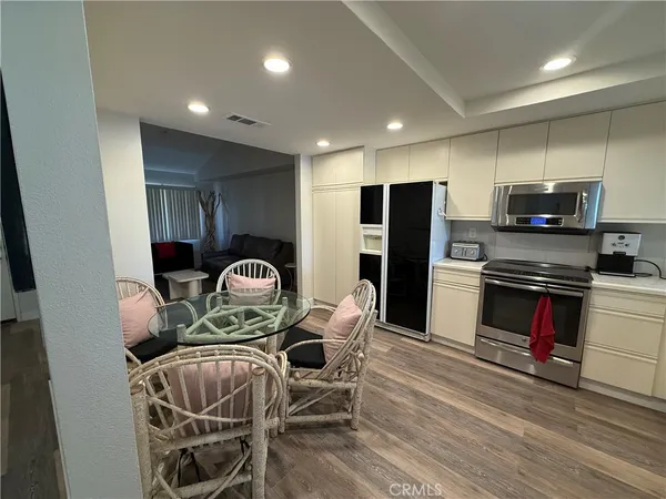 a kitchen with stainless steel appliances kitchen island granite countertop a refrigerator a stove a sink and a microwave