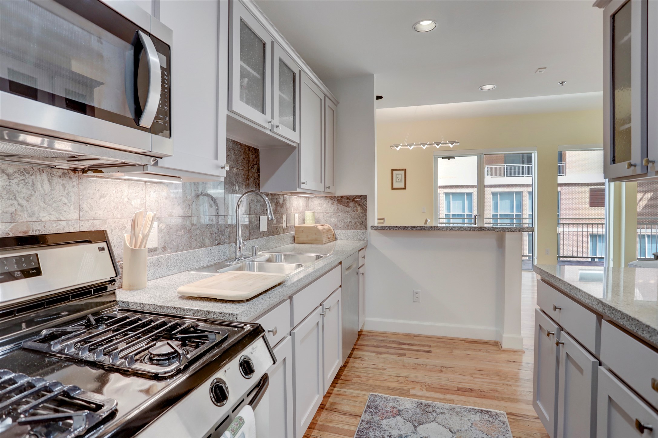 2520 Robinhood Street, Unit 1008 Houston, TX 77005 - Photo 12 of 27 a kitchen with stainless steel appliances granite countertop a stove and a sink