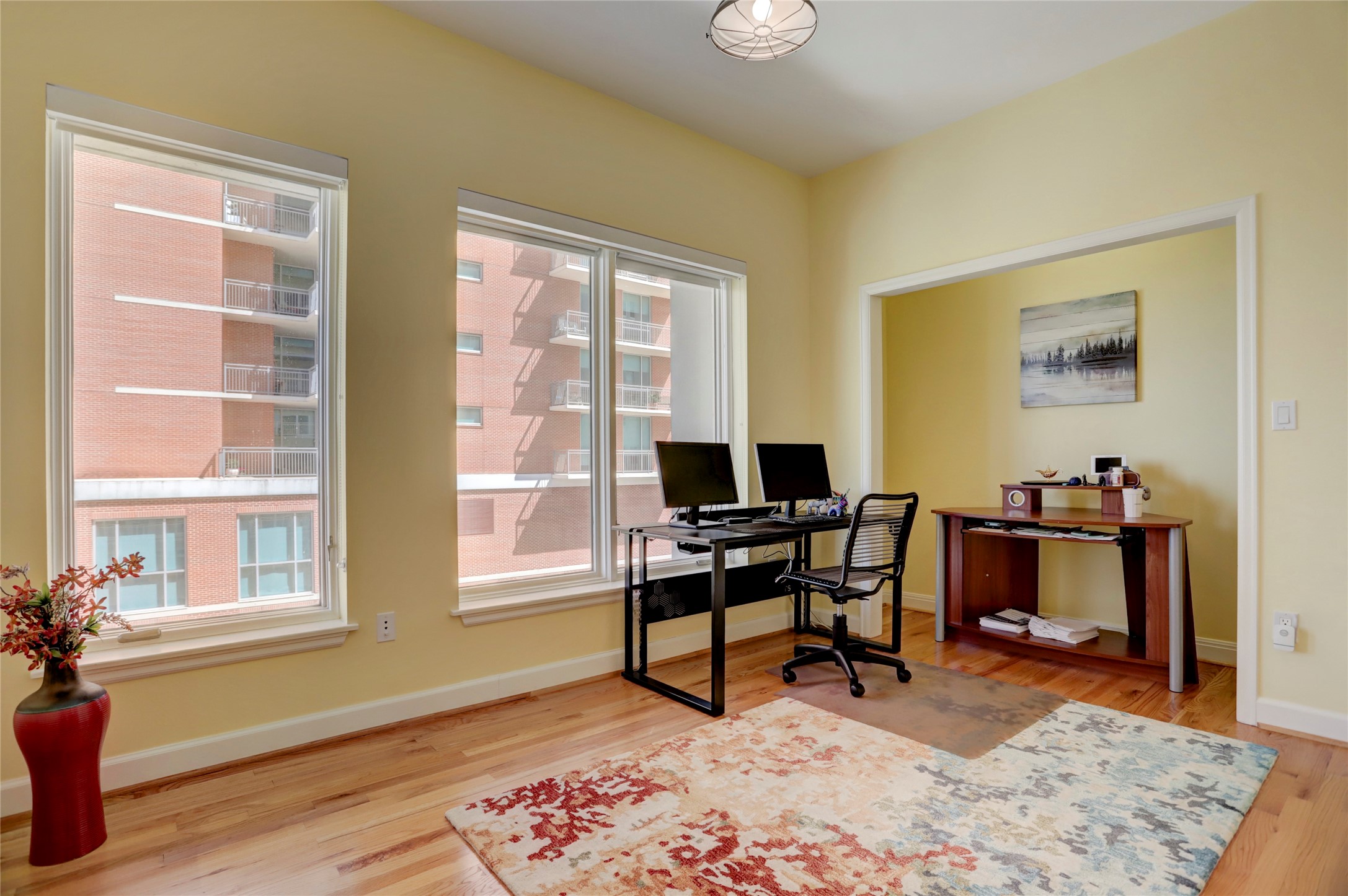 2520 Robinhood Street, Unit 1008 Houston, TX 77005 - Photo 14 of 27 a workspace with wooden floor and a window