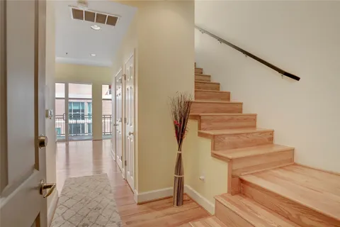 a view of entryway and hall with wooden floor