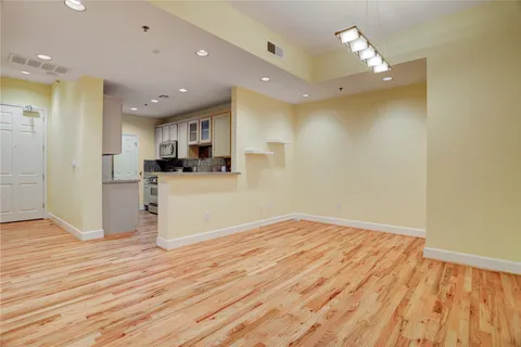 a view of a kitchen with wooden floor and a sink