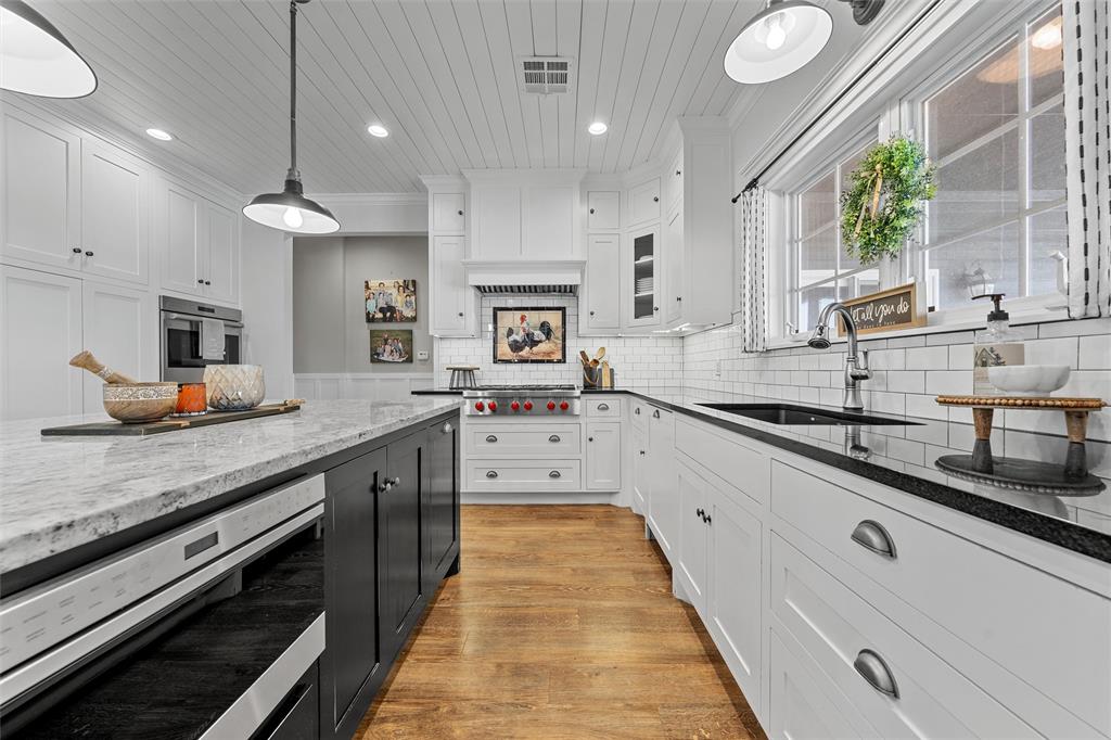 2045 Iron Bridge Road Lorena, TX 76655 - Photo 12 of 40 a large kitchen with stainless steel appliances kitchen island granite countertop a sink and a stove
