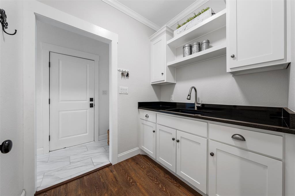 2045 Iron Bridge Road Lorena, TX 76655 - Photo 18 of 40 a kitchen with granite countertop white cabinets and sink