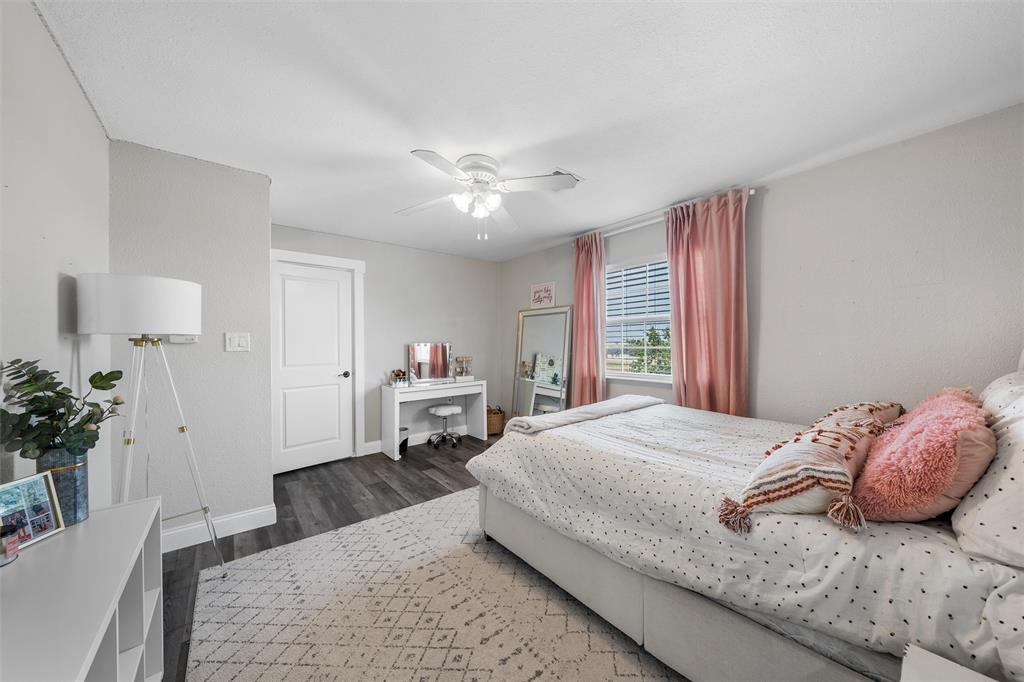 2045 Iron Bridge Road Lorena, TX 76655 - Photo 24 of 40 a bedroom with a bed and a chandelier