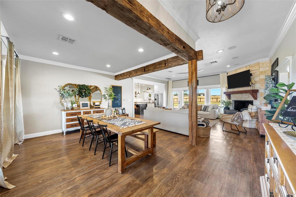 2045 Iron Bridge Road Lorena, TX 76655 - Photo 3 of 40 a view of a dining room with furniture and wooden floor