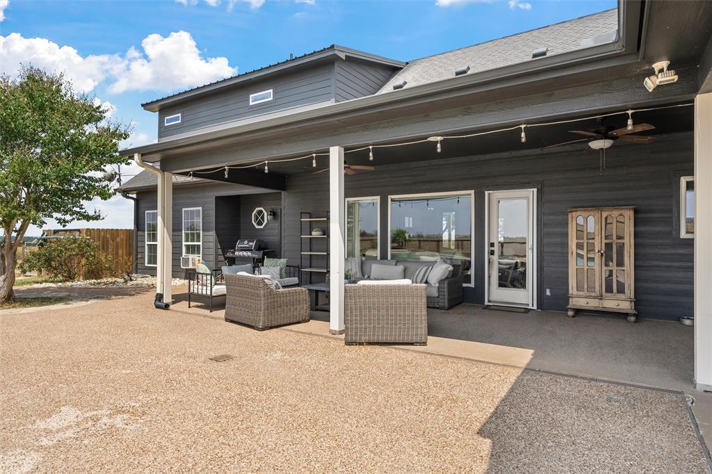 2045 Iron Bridge Road Lorena, TX 76655 - Photo 31 of 40 a view of a patio with dining table and chairs and potted plants