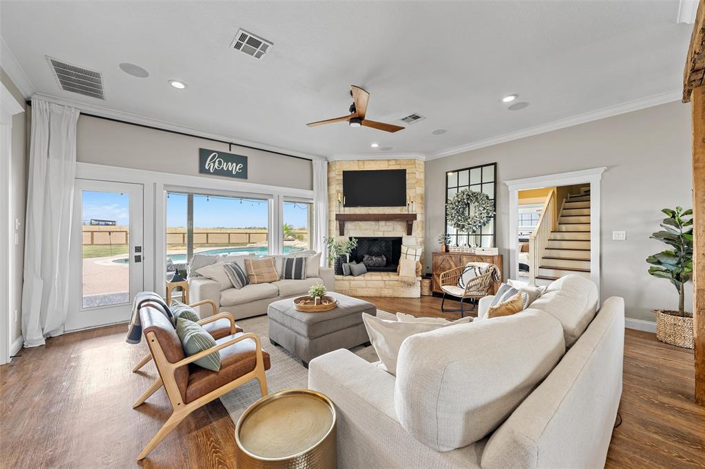 2045 Iron Bridge Road Lorena, TX 76655 - Photo 7 of 40 a living room with fireplace furniture and a wooden floor