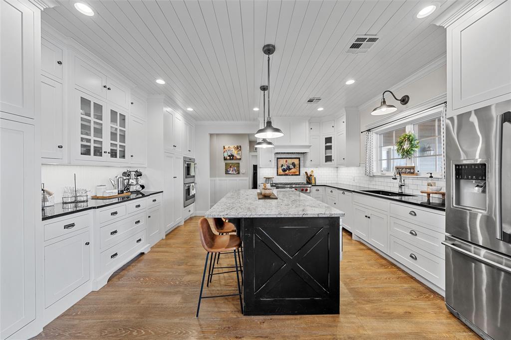 2045 Iron Bridge Road Lorena, TX 76655 - Photo 9 of 40 a kitchen with stainless steel appliances kitchen island granite countertop a stove a sink and a refrigerator