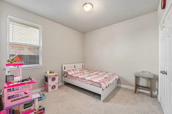 a bedroom with a bed and a window