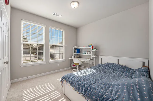 a bedroom with a bed and a desk