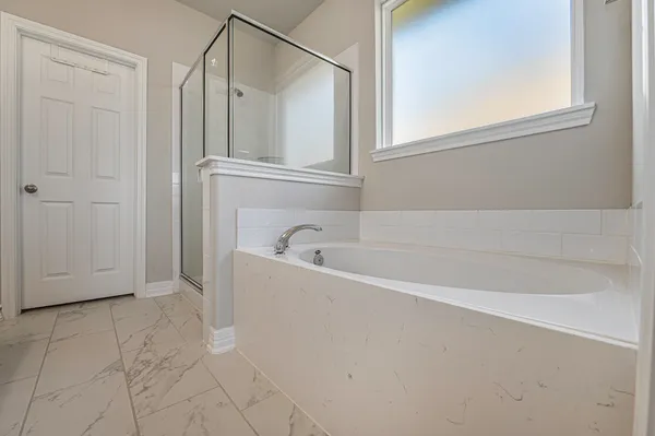a bathroom with a bathtub and a shower