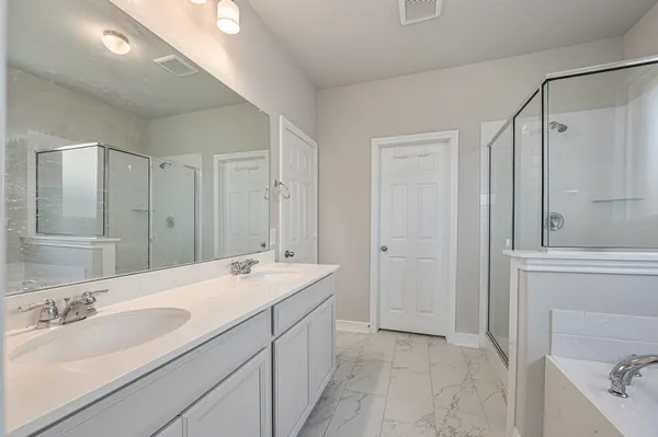 a bathroom with a double vanity sink mirror and double