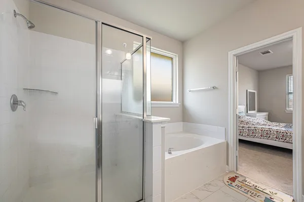 a bathroom with a tub and shower