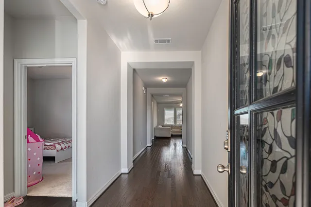 a view of a hallway with a livingroom and a way to other room