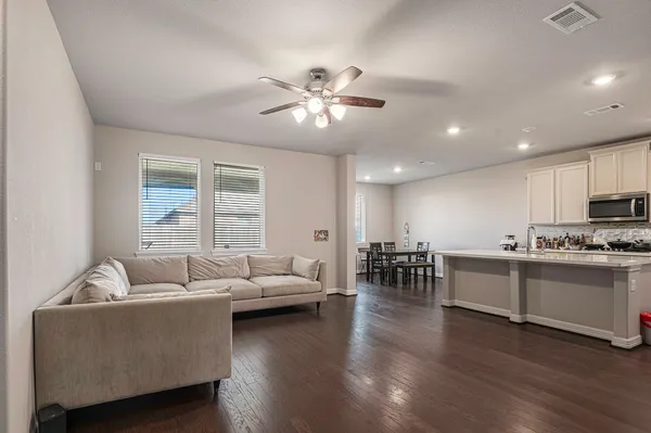 a living room with furniture and kitchen view
