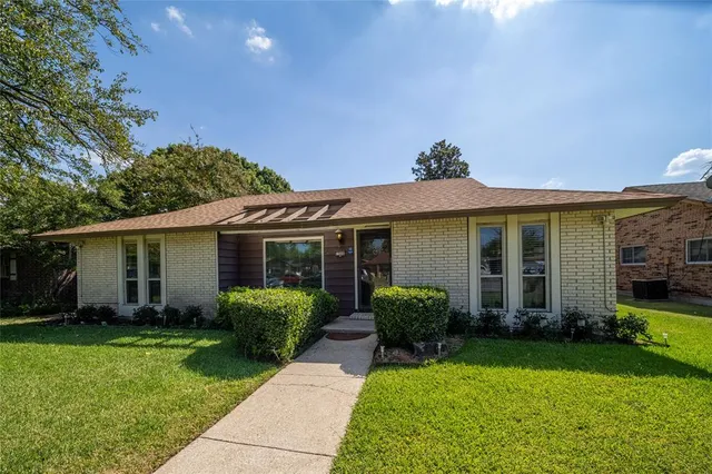 a view of a house with garden and plants