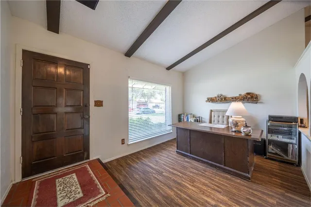 a view of workspace with wooden floor and cabinet