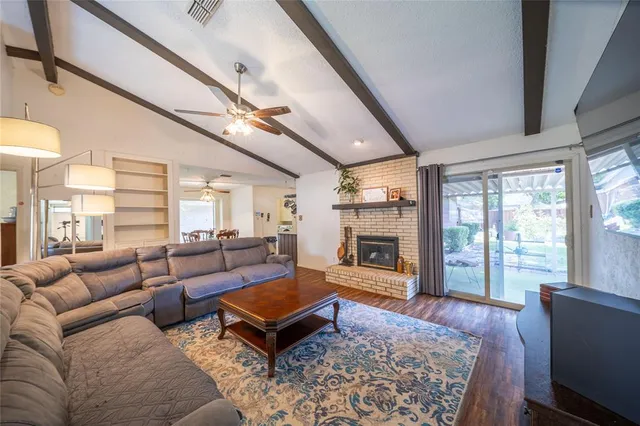 a living room with furniture a fireplace and a table