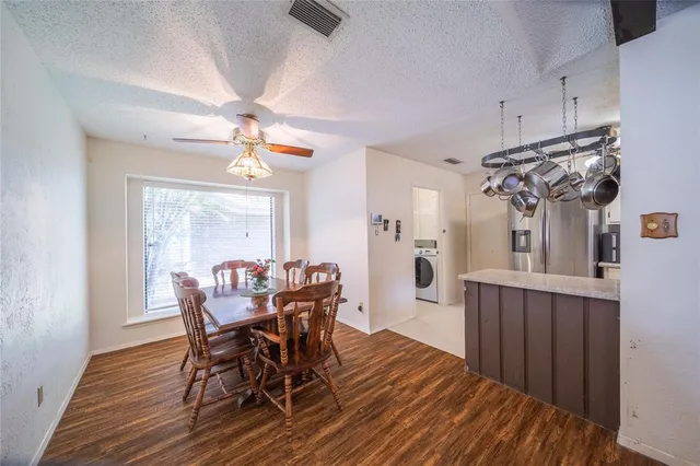 a view of a dining room with furniture and window