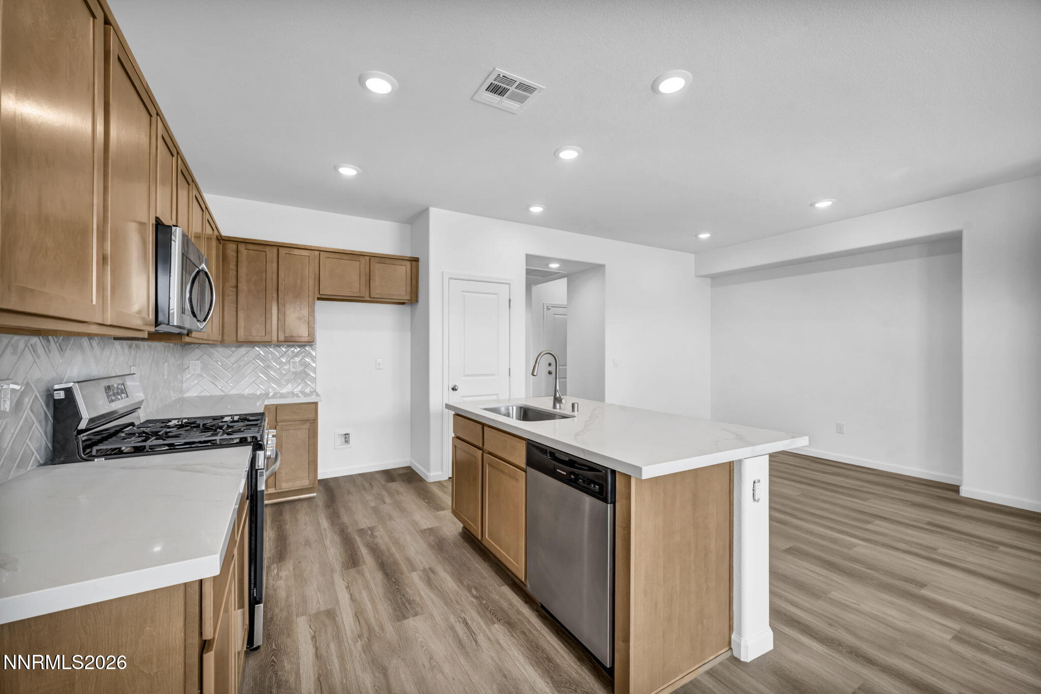 6676 Morgan Mill Road, Unit HOMESITE 14 Carson City, NV 89701 - Photo 2 of 24 a kitchen with stainless steel appliances granite countertop a stove and a sink